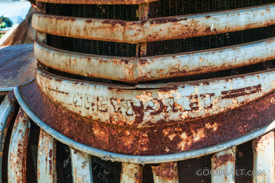 Close-up of rusty Chevrolet truck grill.
