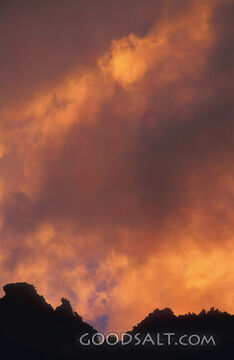 Cloudy Sunset With Mountain Silhouette