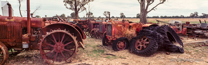 Collection of rusty historic tractors.