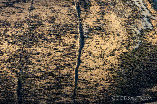 Detail of heavy rock erosion on steep mountainside.