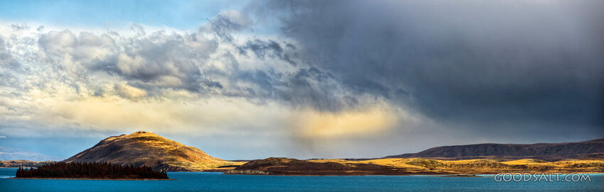 Distinctive yellow and grey cloud hangs over island.