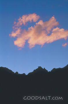 Fluffy Pink Cloud With Blue Sky and Mountain Silhouette