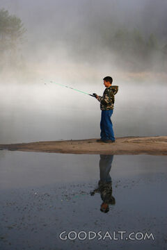 IDAHO. Smith’s Ferry. Boy fishing on foggy morning. MR