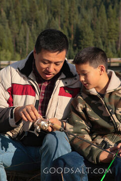 IDAHO. Smith’s Ferry. Man and boy fishing on autumn morning.
