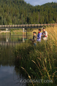 IDAHO. Smith’s Ferry. Man and kids fishing on autumn morning