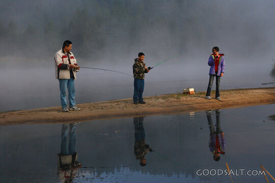 IDAHO. Smith’s Ferry. Man and kids fishing on foggy morning.