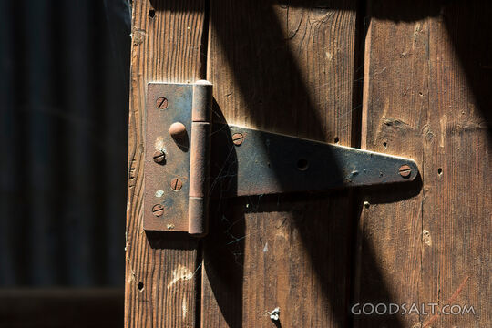 Interior of heritage shearing shed showing old cupboard door.