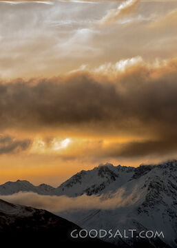Late sunset and low clouds over range.