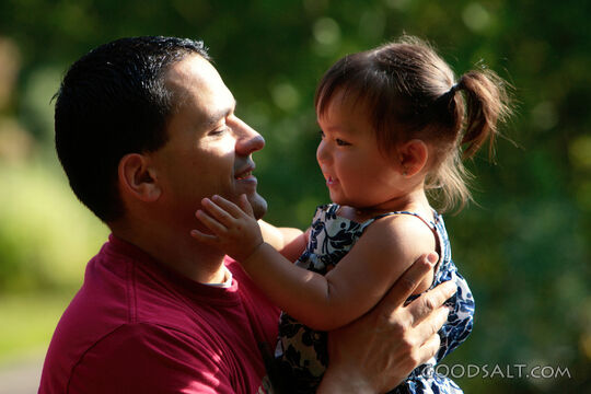 Little girl kissing her daddy.