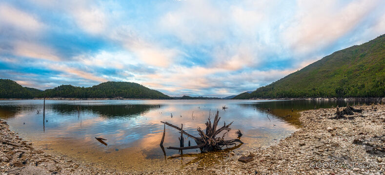 Perfect mirrored lake and shores at sunrise.