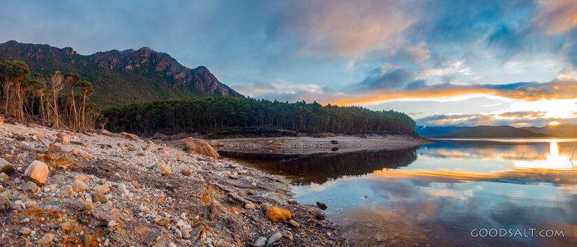 Perfect mirrored lake and shores at sunrise.