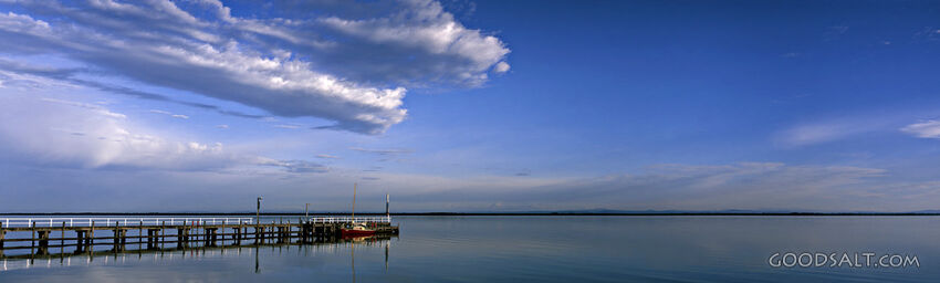 Pier on Lake With Fluffy Clouds