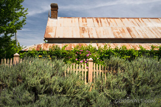Pioneering residence with pickwt fence.