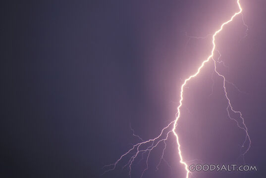 A flash of lightning in a dark sky.