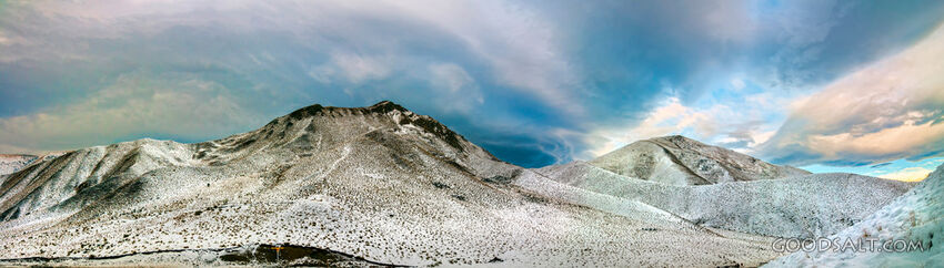 Snow covered mountain range and dramatic cloud effects.