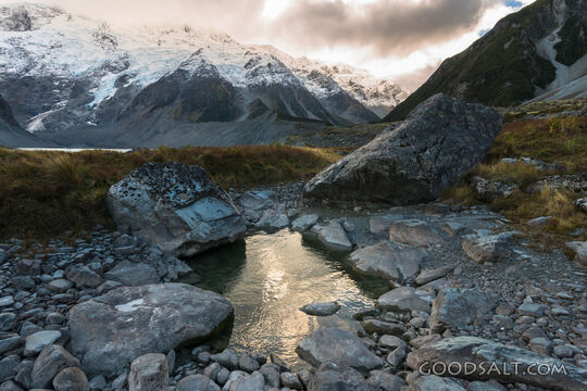 Spectacular alpine scenery of rocks, boulders, snow and water.