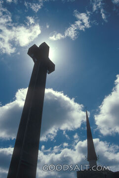 A silhouette of a cross and steeple.
