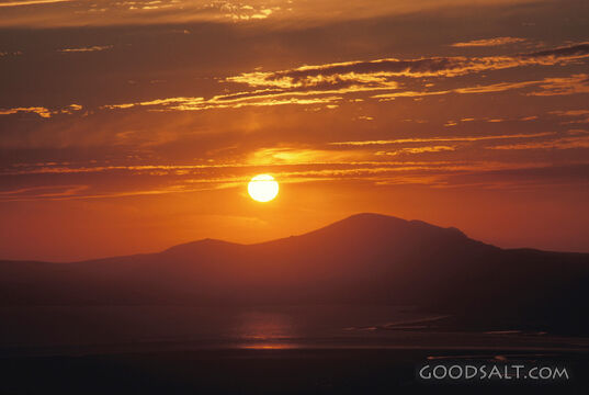 An orange sunset over distant mountains.