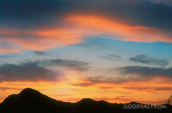 Sunset With Clouds and Mountain Silhouette