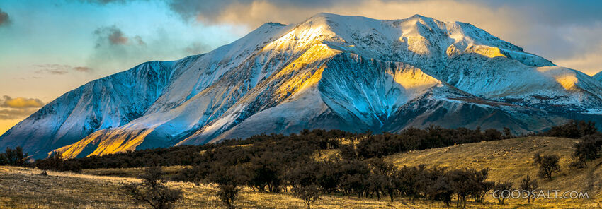 The light of the early sunrise collides with a mountainside.