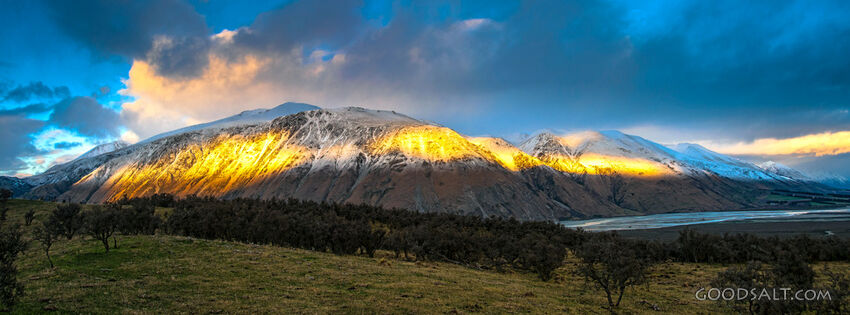 The light of the early sunrise collides with a mountainside.