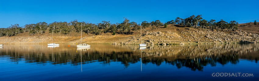 Yachts moored on a perfect still lake.
