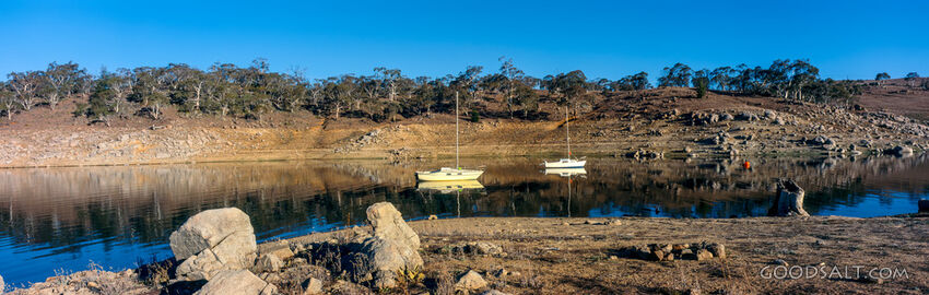 Yachts moored on a perfect still lake.
