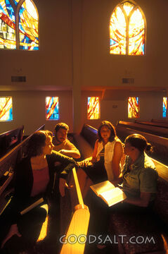 A group of people studying in a church.