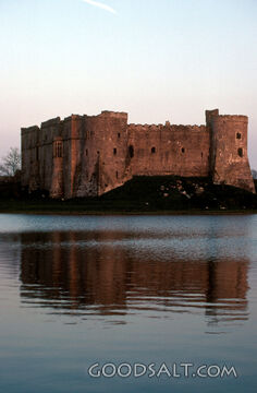 ancient castle reflected in a rippling lake