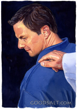 A hand touching a man on his shoulder.
