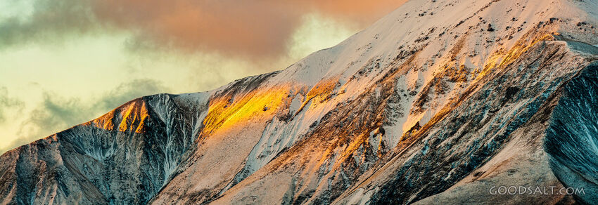 Close detail of mountainside struck by golden morning sunlight.
