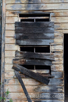 close-up of boarded up window on old shed
