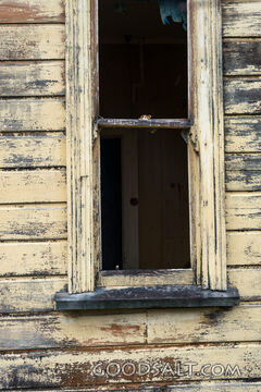 close-up of decayed window on old shed