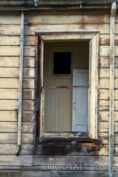 close-up of decayed window on old shed
