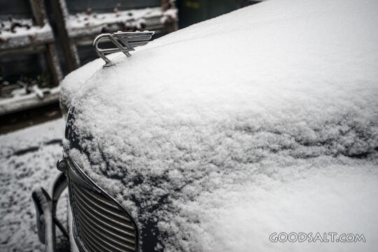 Details of snow covered classic car.