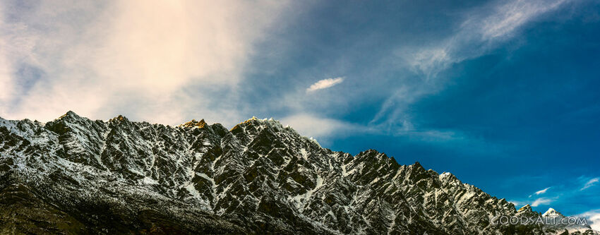 dramatic mountain range with snow and rock.