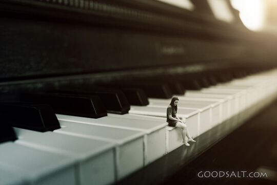 Girl Sitting on a Piano