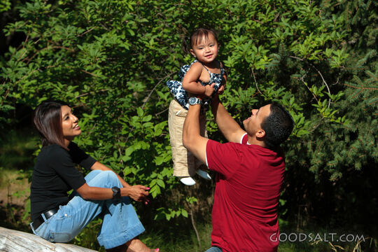 Happy family playing in park.