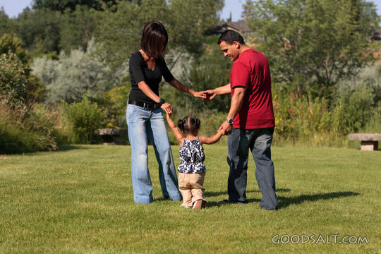 Happy family playing in park.
