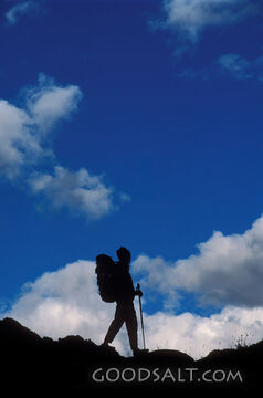Hiker Silhouette Against Blue Sky