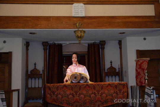 IDAHO. Boise. Asian Jewish girl standing at bimah in synagog