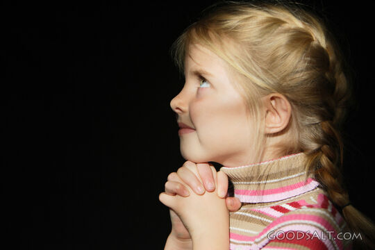 IDAHO. Boise.  Little girl looking up and praying. MR