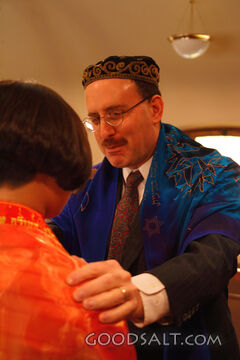 IDAHO. Boise. Rabbi blessing Asian Jewish girl on the bimah 