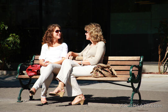 IDAHO. Boise. Two women seated on bench, talking.  MR