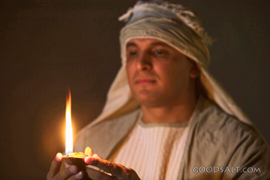 Isrealite Man Holding Lit Lamp in the Dark