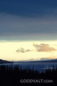 big sky over pine rimmed lake