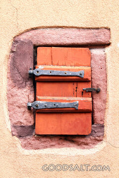 Rustic Shutter in Stone Wall