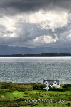 Coastal Cottage Under Storm Clouds