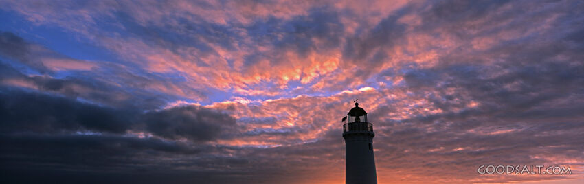 Lighthouse at Sunset With Pink Clouds