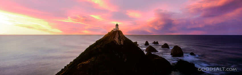 lighthouse on very high pointed peak, sunrise.